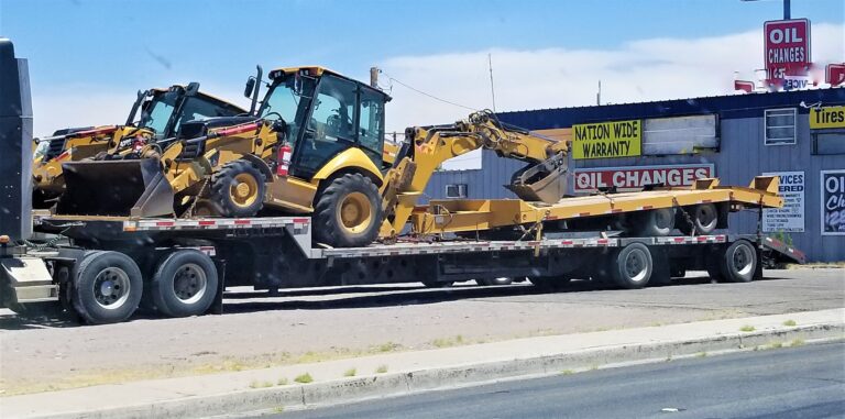 lowboy trailer with construction vehicles